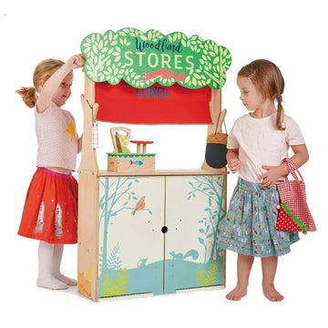 Children playing at a colorful wooden Woodland Stores toy shop.