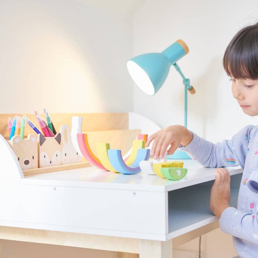 Child playing at the Childs Wooden Drawing Desk and Stool, showcasing spacious storage and adorable animal-themed pencil holders.