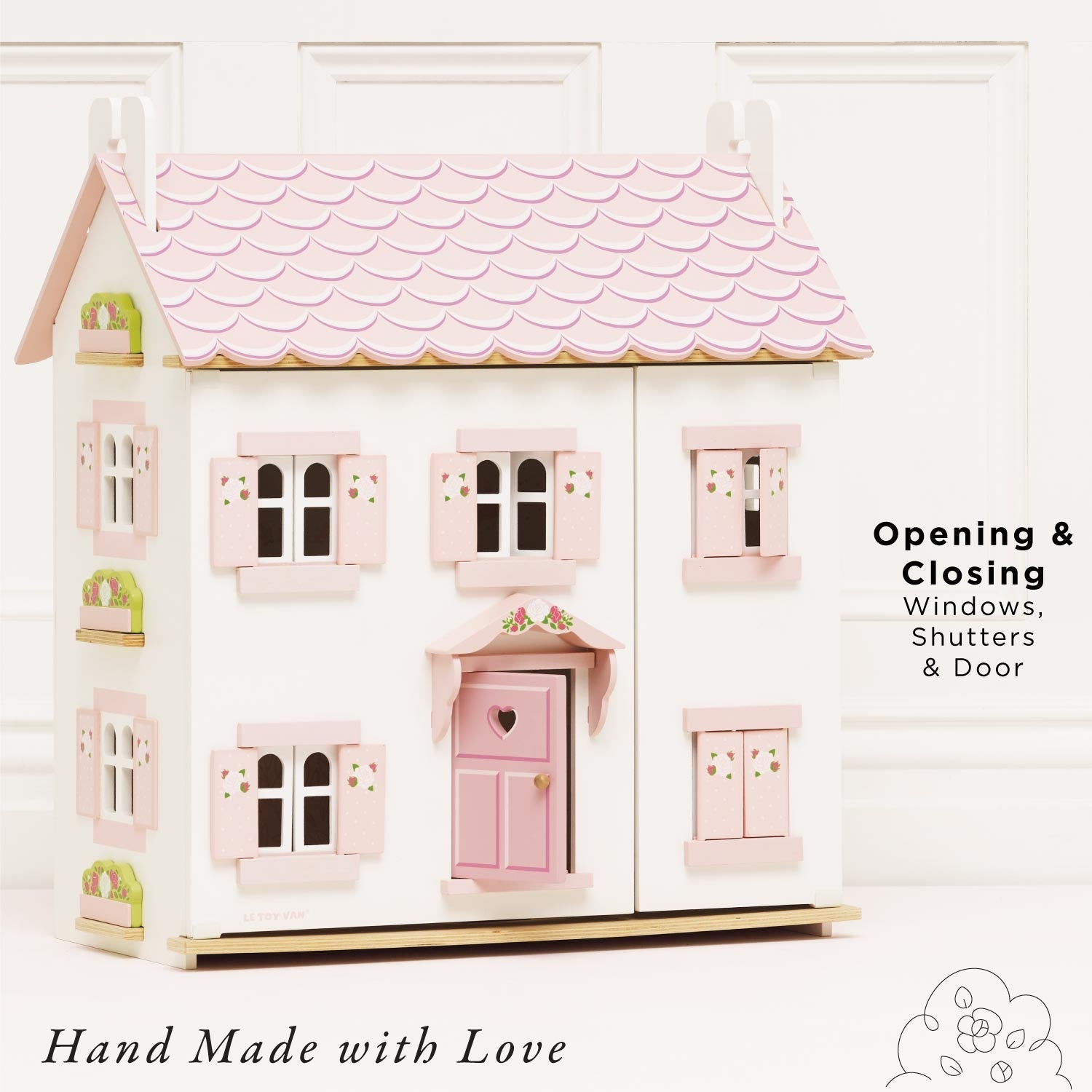 Le Toy Van Sophie's Wooden Dolls House featuring opening windows, shutters, and door, handcrafted from sustainable wood.