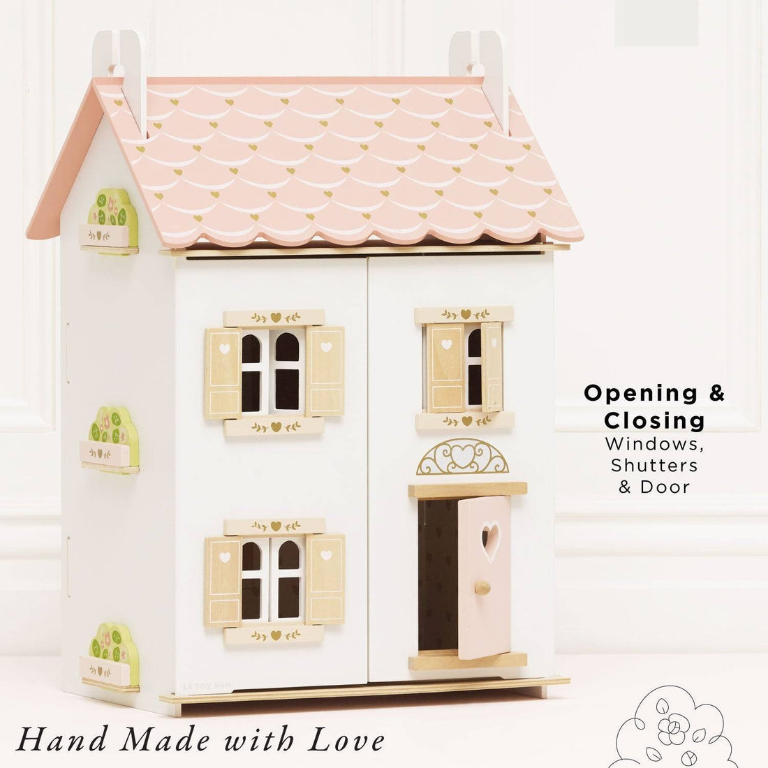 Le Toy Van Roseheart Wooden Dolls House with pink scalloped roof, heart-shaped door, and shuttered windows, ideal for imaginative play.