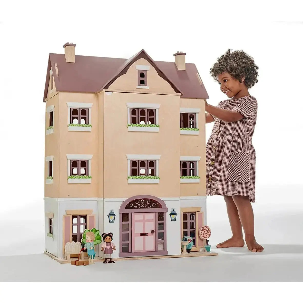 Child playing with Fantail Hall deluxe wooden dolls house, highlighting its large size and intricate design for immersive imaginative play.