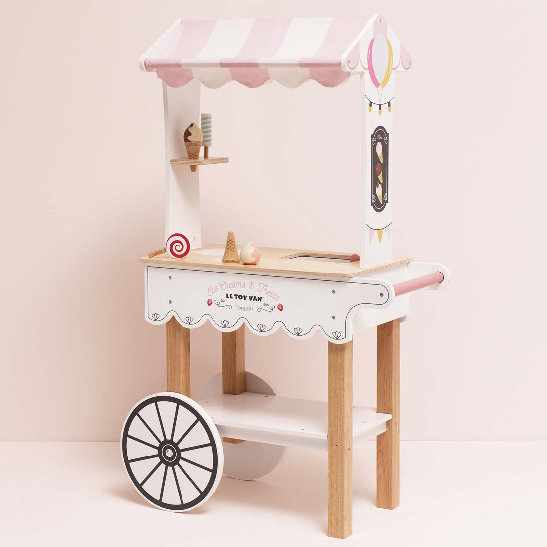 Le Toy Van Wooden Ice Cream Trolley - Toy Ice Cream Stall with pink canopy, wooden wheels, and display shelf for pretend play.