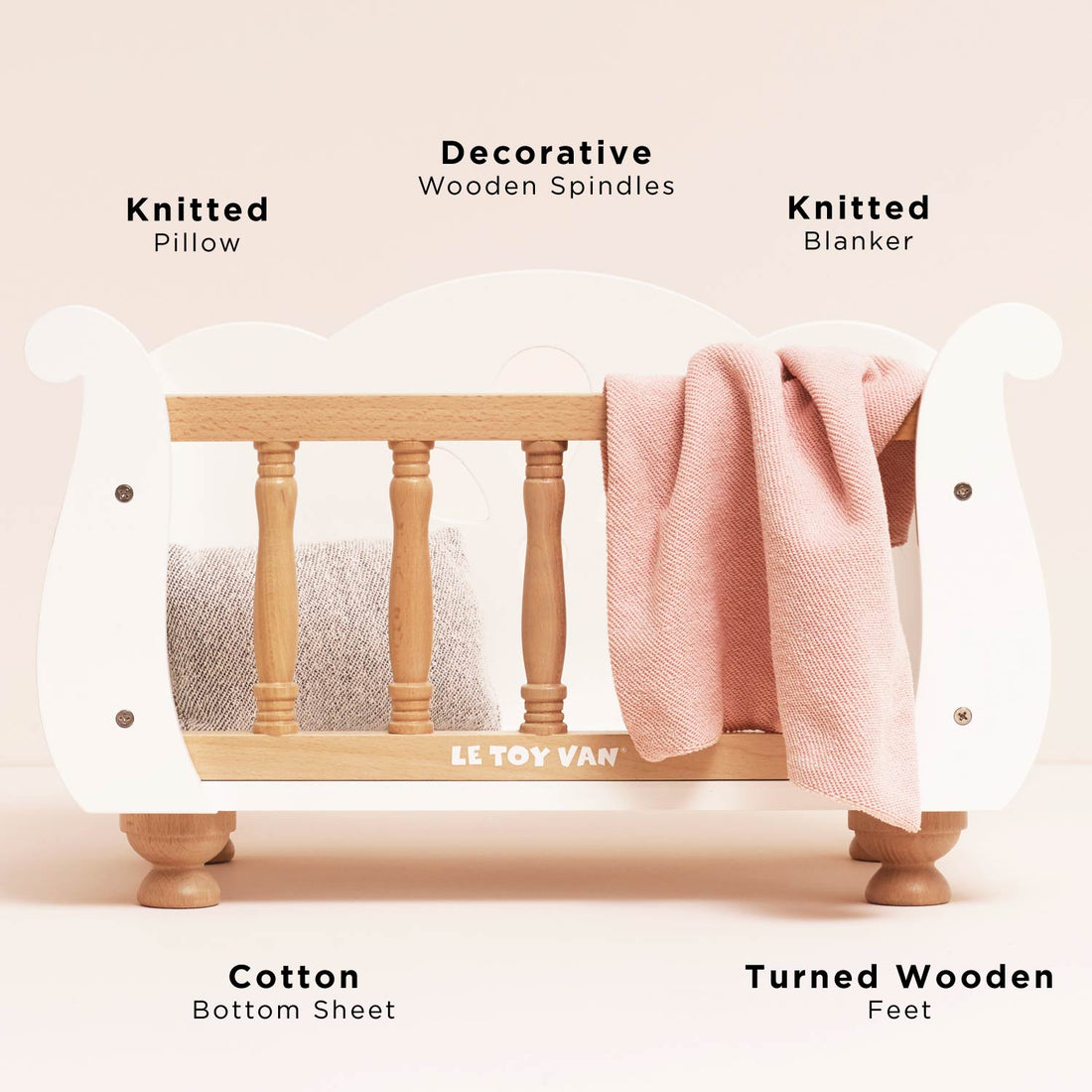 Ley Toy Van Dolls Cot crib cradle made from FSC wood with turned wooden feet and bedding, ideal for pretend play for kids aged 3+.