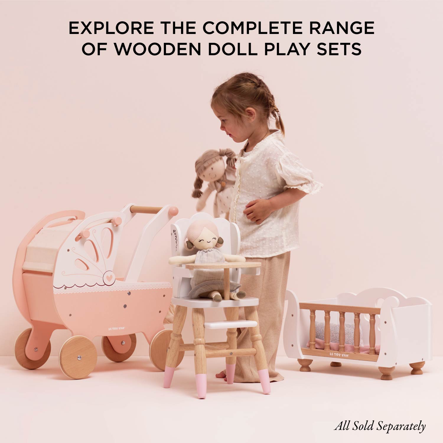 Child playing with Ley Toy Van Dolls Cot, pram, and high chair, part of a wooden doll playset collection sold separately for imaginative play.