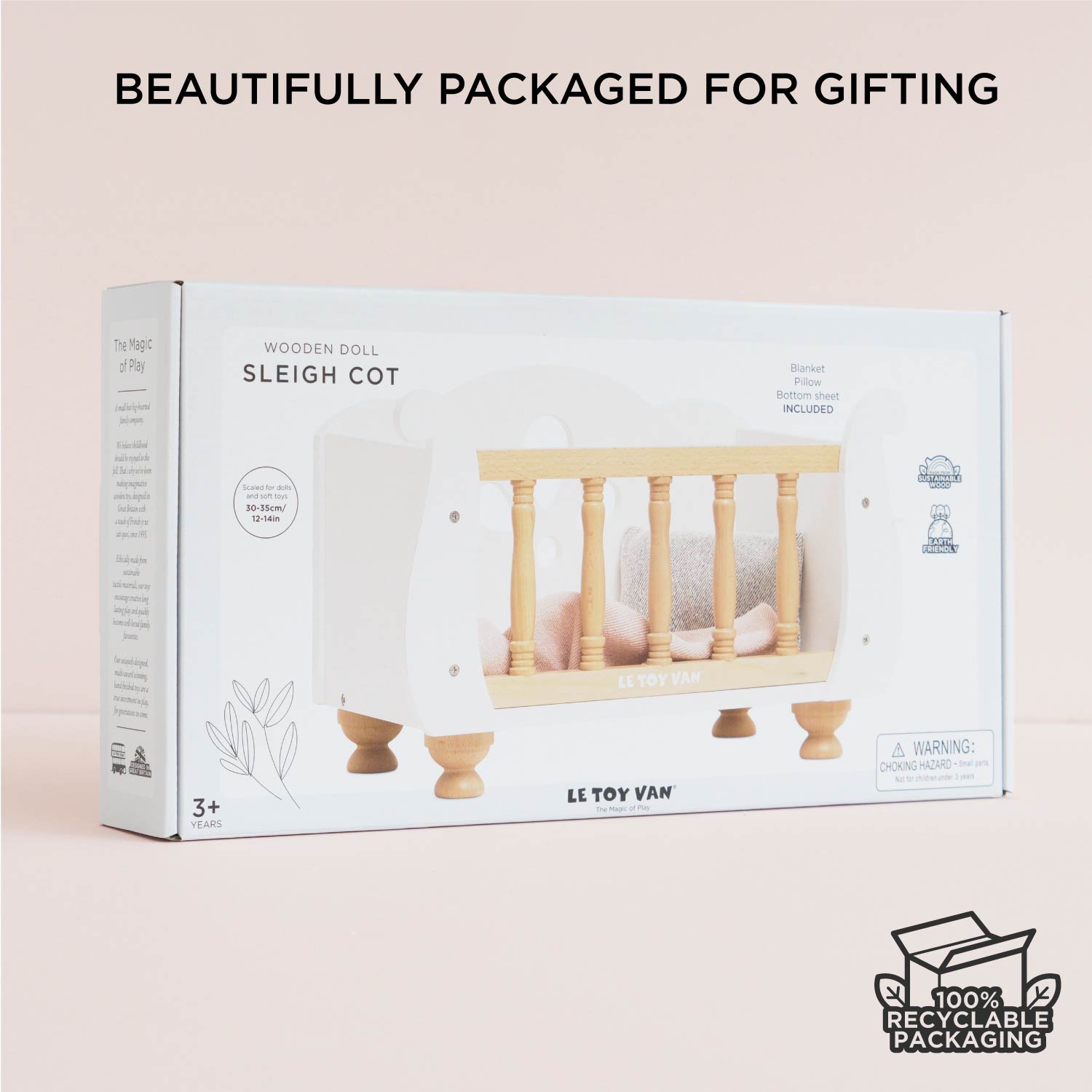 Ley Toy Van Dolls Cot in eco-friendly gift packaging, includes blanket, pillow, and sheet, ideal for children aged 3+ and doll role play.