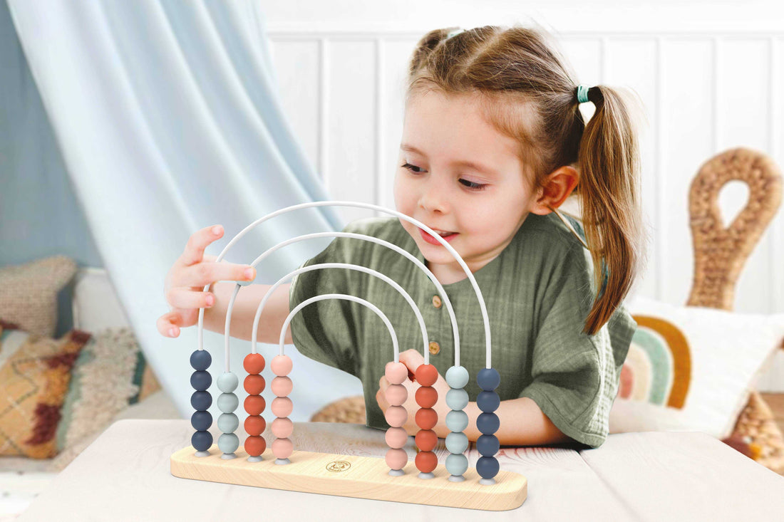 Speedy Monkey Wooden Rainbow Abacus with pastel-colored beads on a natural wood base, designed for preschool counting and learning activities.