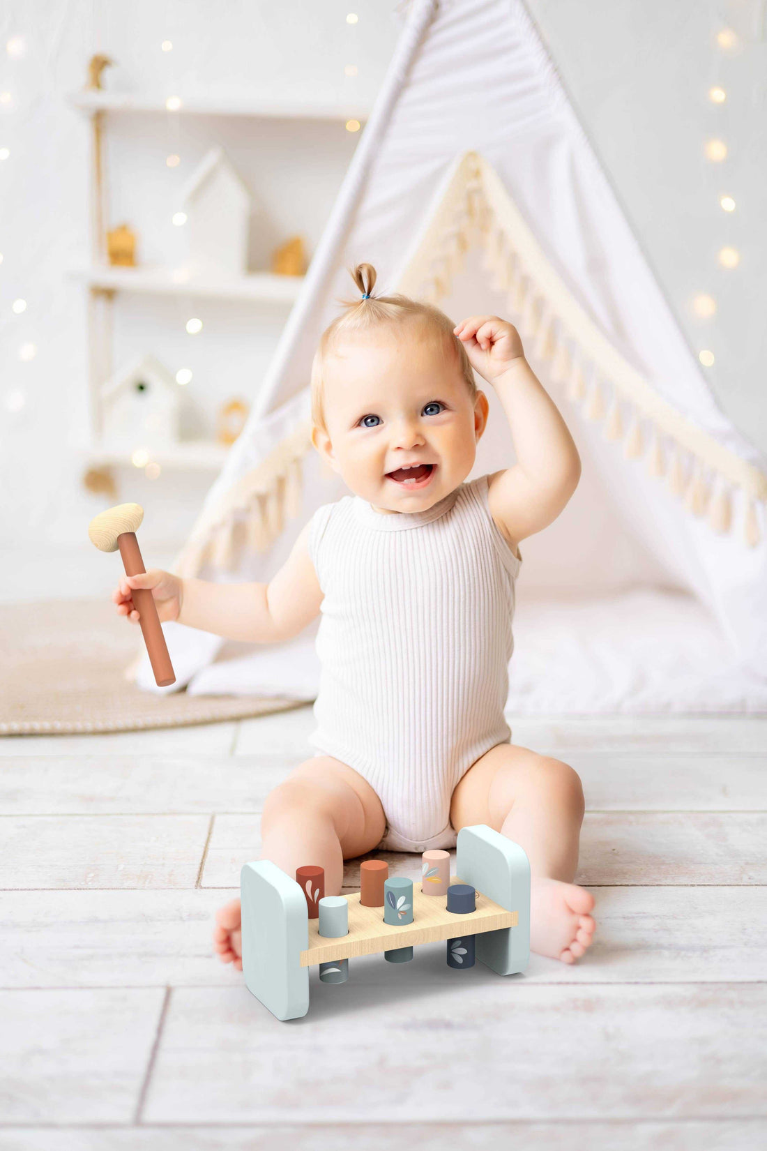 Speedy Monkey Hammer Peg Bench wooden toy with pastel-colored pegs and hammer, designed for toddler hand-eye coordination and motor skill development.