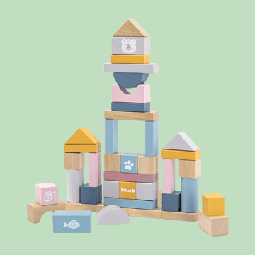 Colorful wooden building blocks arranged in a castle-like structure, featuring pastel shades of blue, pink, yellow, and natural wood, with animal and paw print illustrations.