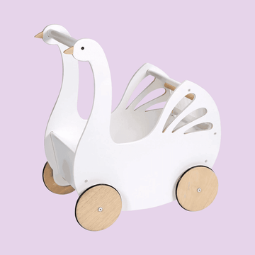 White wooden swan-shaped baby walker with natural wood wheels and cut-out wing details, designed for toddlers learning to walk.