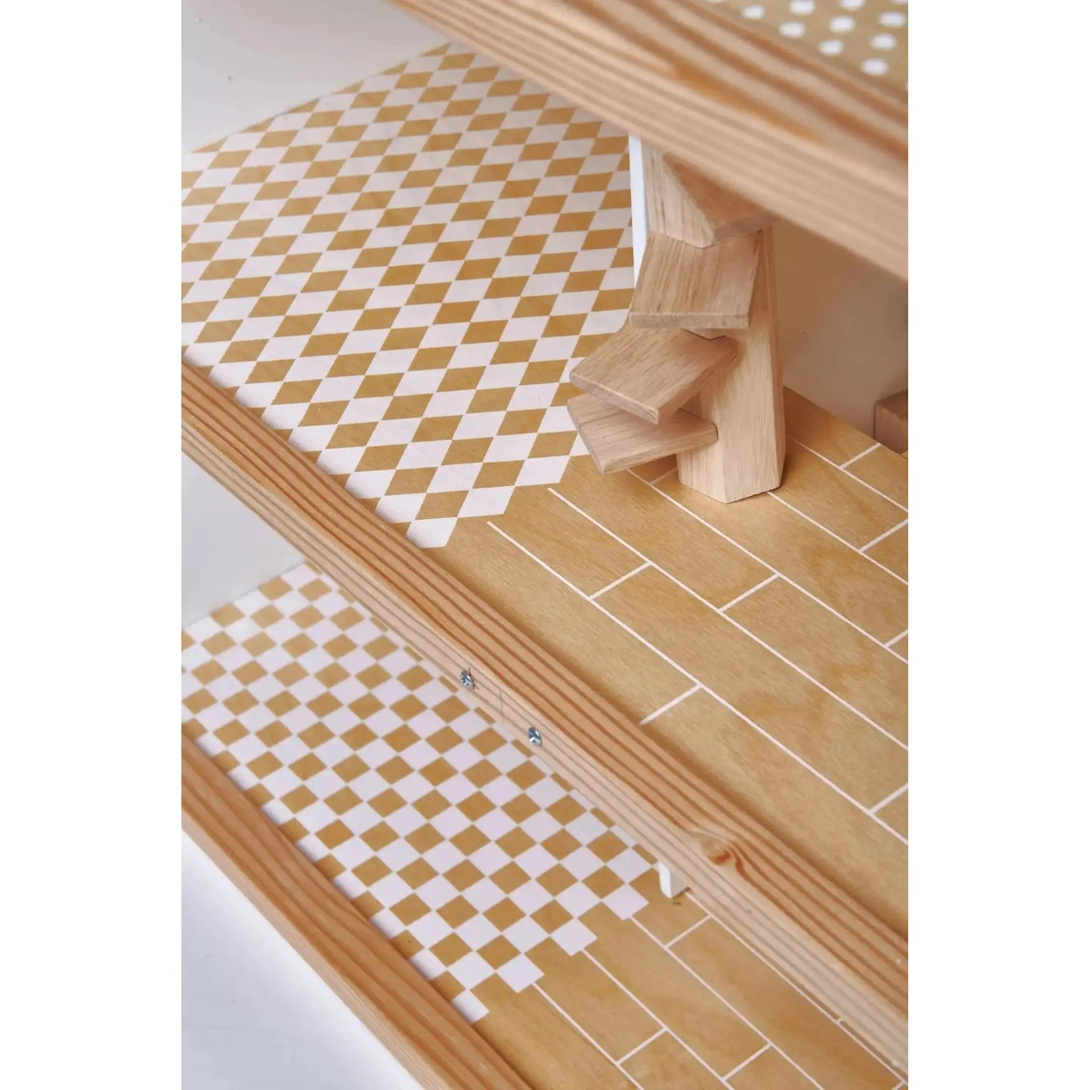 Close-up of the Dovetail House Wooden Dolls House flooring, featuring detailed checkered and wood-patterned designs for a realistic touch.